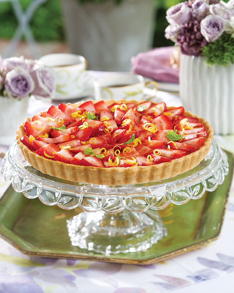 Strawberry tart on a clear cake stand