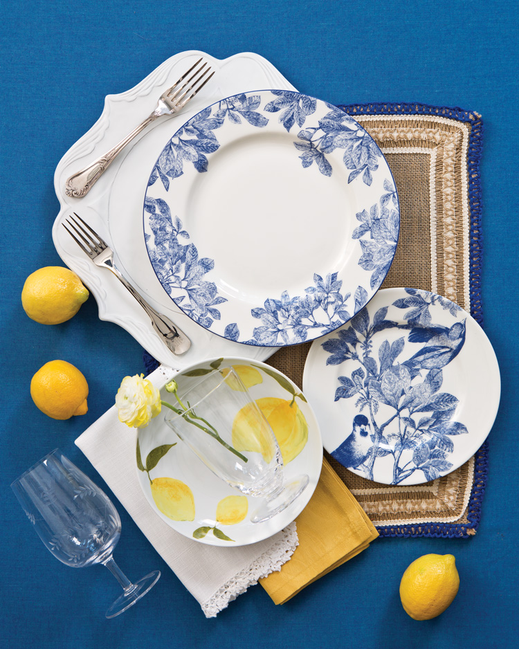 A picture of pieces for two blue and white table settings