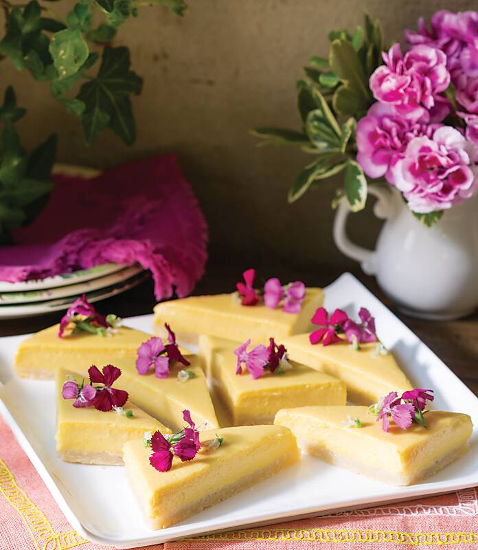 Mango Key-Lime Bars garnished with pink edible flowers