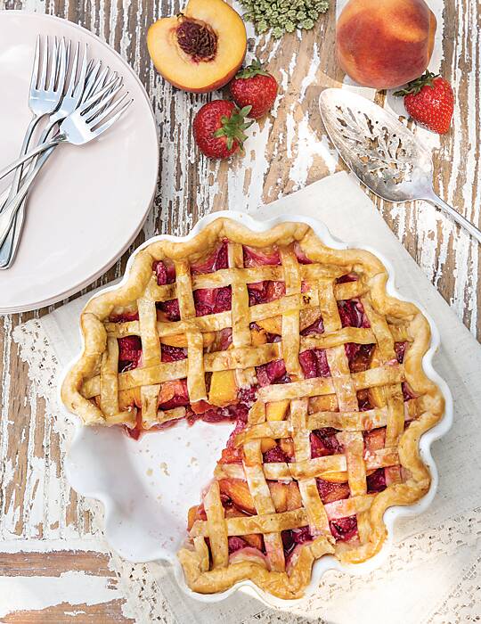 Strawberry-Peach Pie in a white ruffle-edge dish