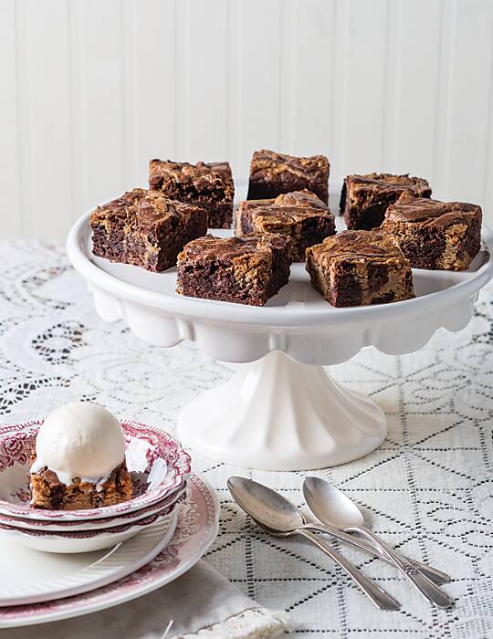 Swirled Peanut Butter Brownies on a white cake stand