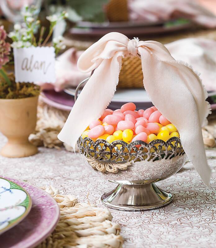 Pink and yellow jelly beans in a silver candy dish