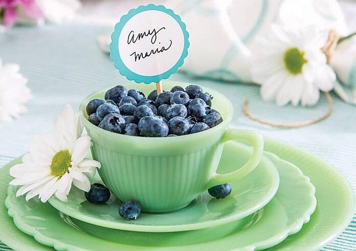 Blueberries in a mint green teacup with a place card