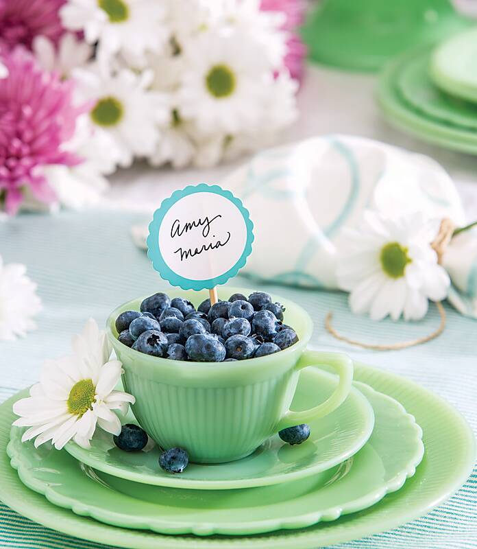 Blueberries in a mint green teacup with a place card