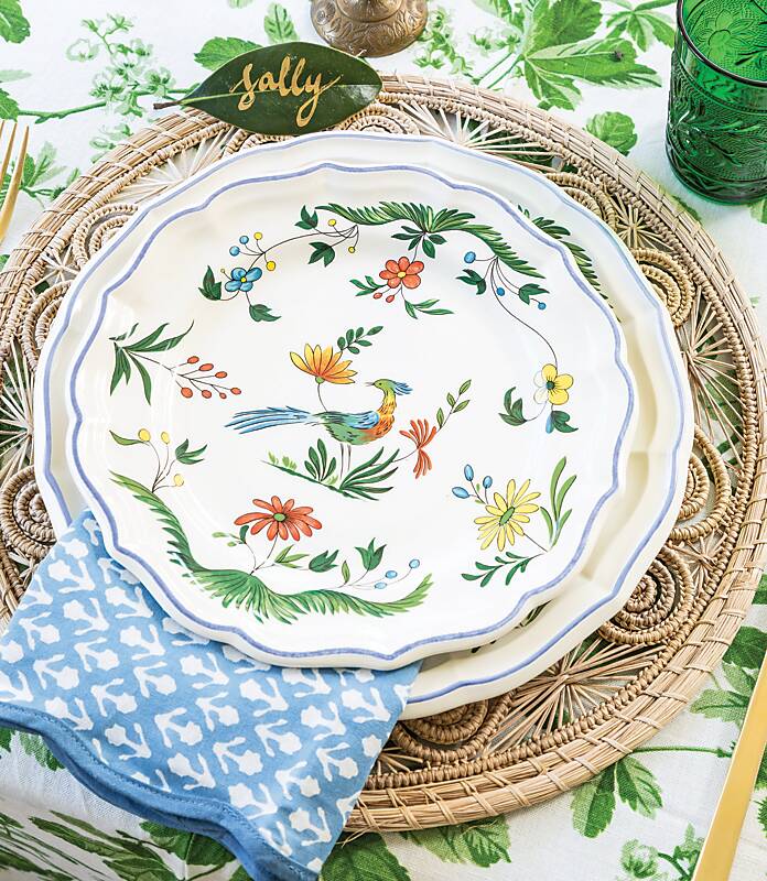 Place setting of wicker place mat and garden-motif plate