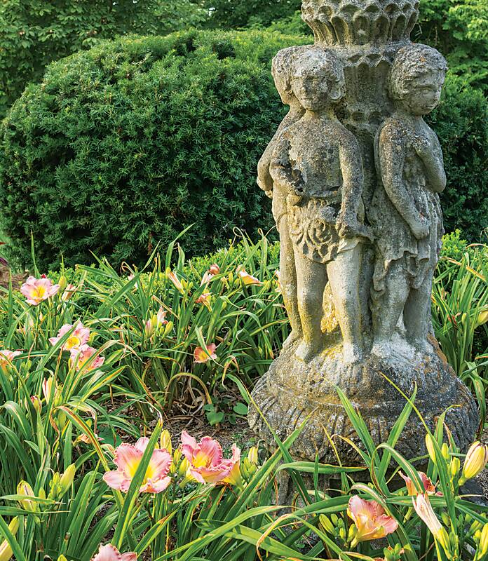 Garden statuary amid pink lilies