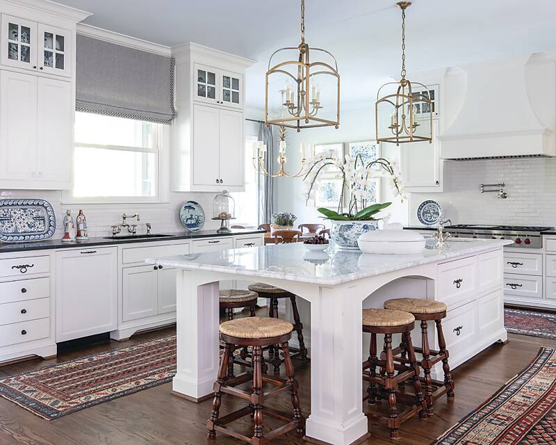 All-white kitchen with 3 Oriental runners and gold light fixtures