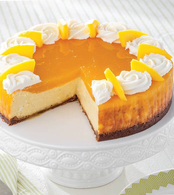 Mango Cheesecake on a white cake stand