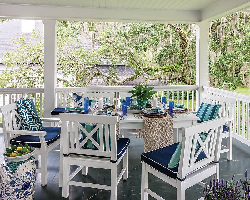 A blue-and-white tablescape on a waterfront porch