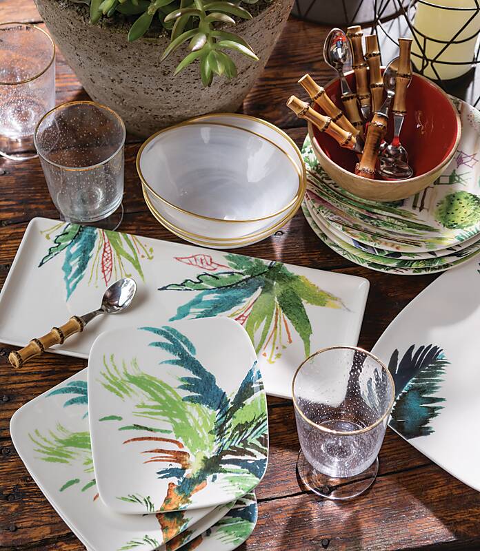 White plates and bowls with palm leaf motifs