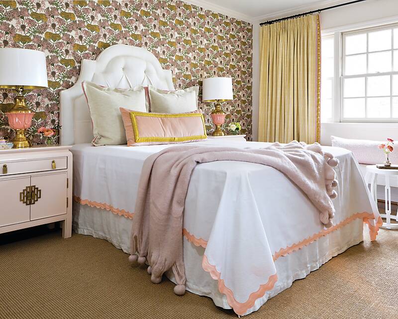 A bedroom featuring pink floral wallpaper