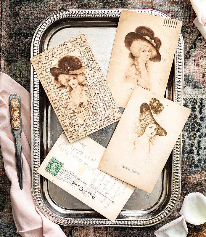 Antique postcards featuring hand-drawn women in hats