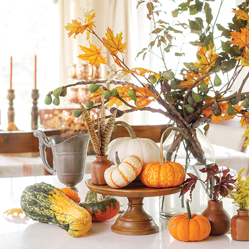 A vignette of pumpkins and branches from Southern Lady's fall special issue Southern Style for Fall 2022