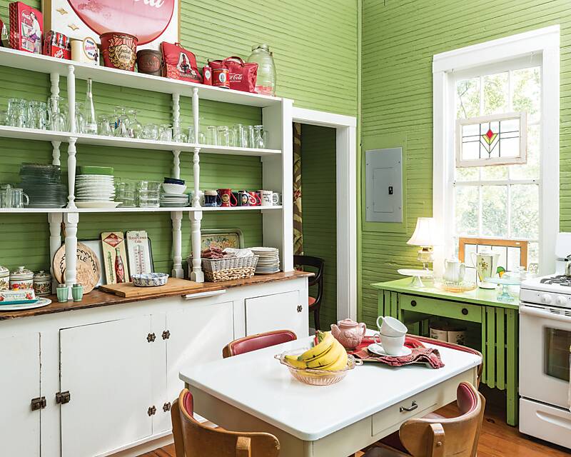 The vintage-inspired kitchen, painted green with white cabinets, of home-cooking sensation Brenda Gantt