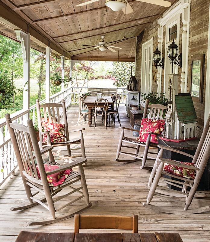 The wooden porch with rocking chairs and red pillows of home-cooking sensation Brenda Gantt