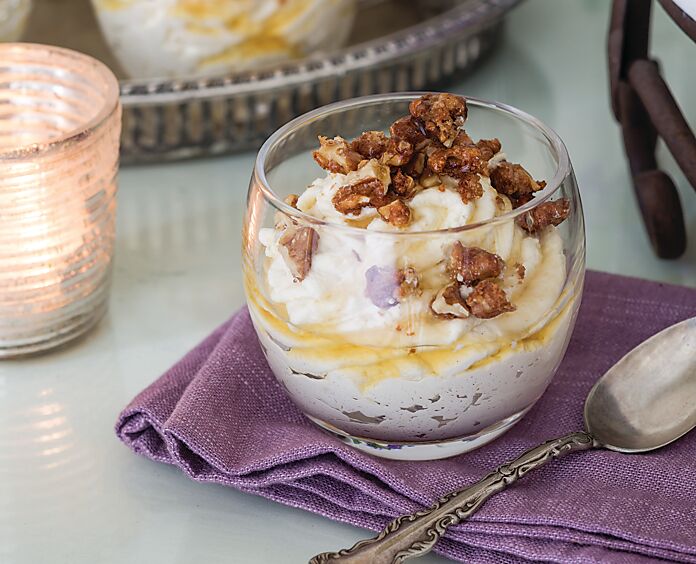 Maple Mousse with Candied Walnuts in a small clear glass on a folded purple linen