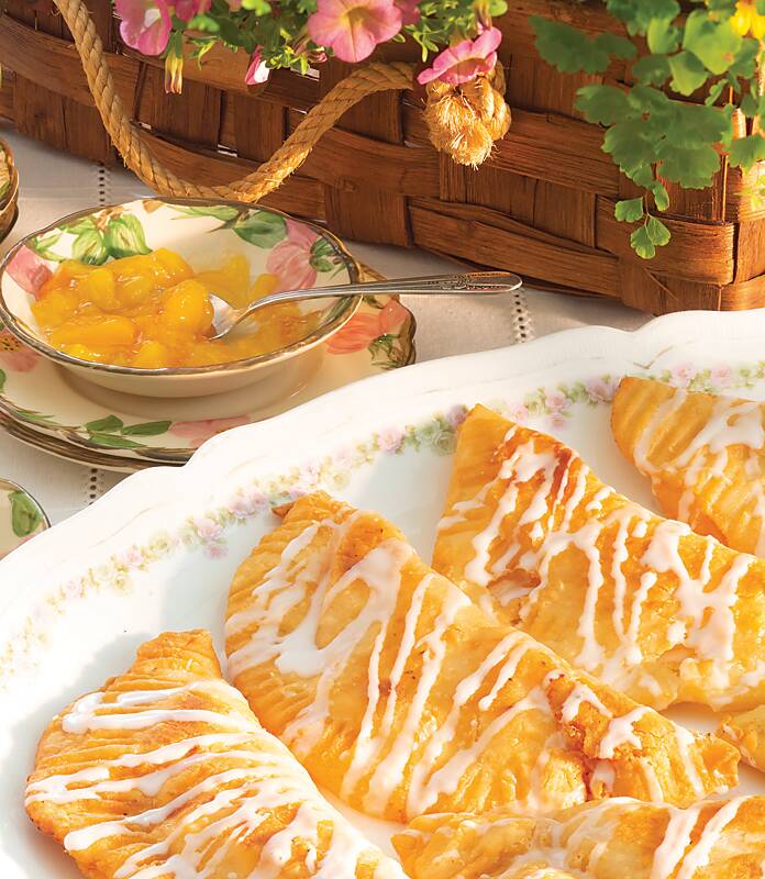 Home-cooking sensation Brenda Gantt serves hand pies drizzled with icing on a floral-rim dish