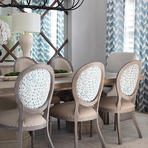 Light wood dining table with blue accent chairs